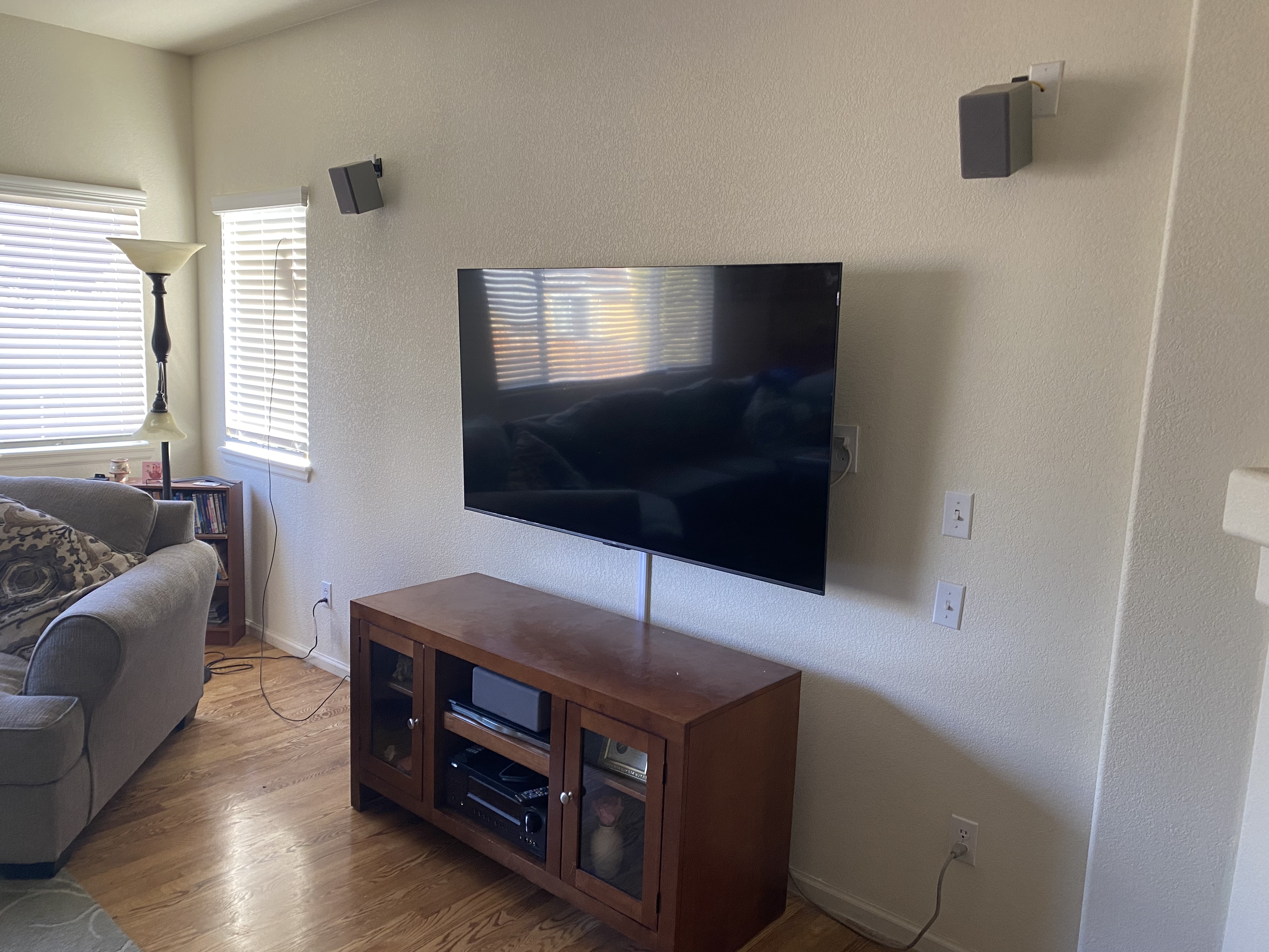 TV mounted on wall with Roku, cord raceway visible
